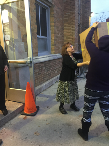 Dr. Garza helps load in gifts. 