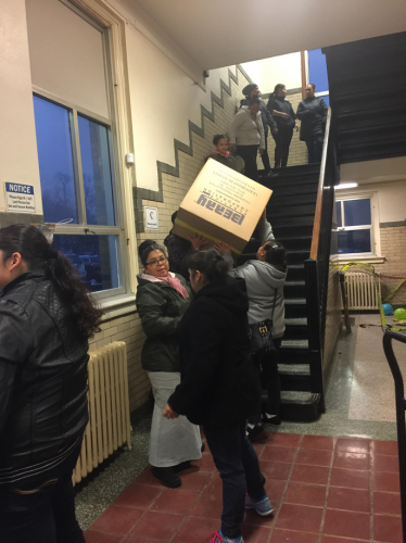 Volunteers load toys and gifts into Bardwell Gym. 