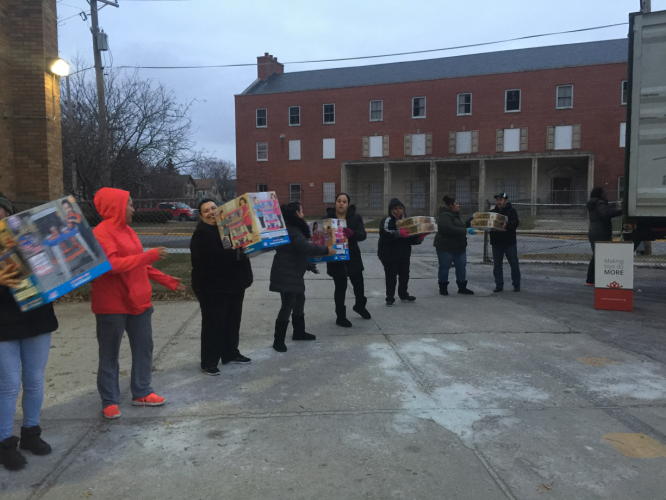 Volunteers load toys into Bardwell School. 