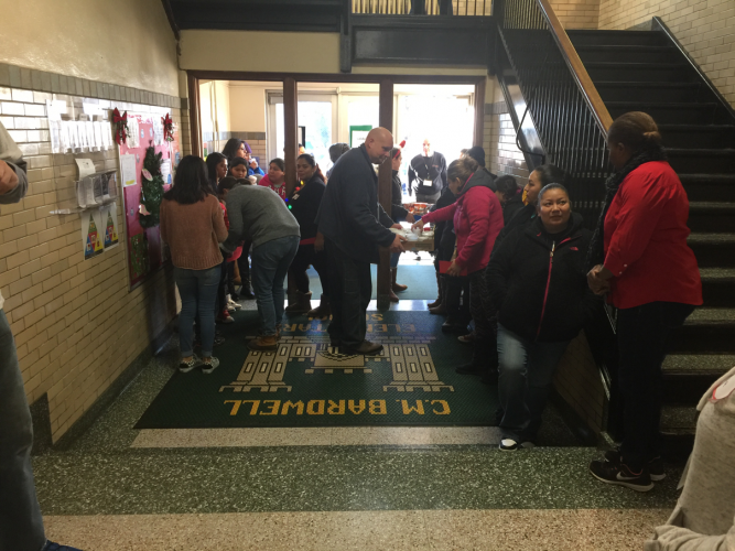 Parents sign in with volunteers. 