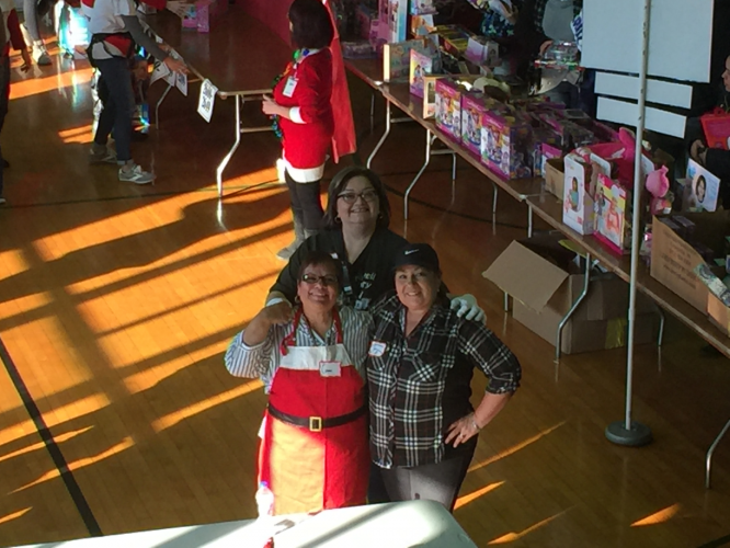 Gift Mart volunteers pose while shopping takes place. 