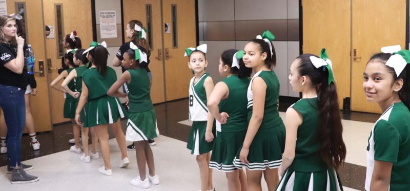 The cheer team anxiously waits on deck