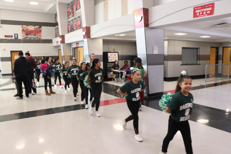 Cheerleaders get ready to begin their performance. 