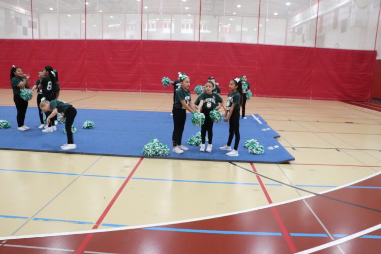 Cheerleaders practice their routine before the tournament.